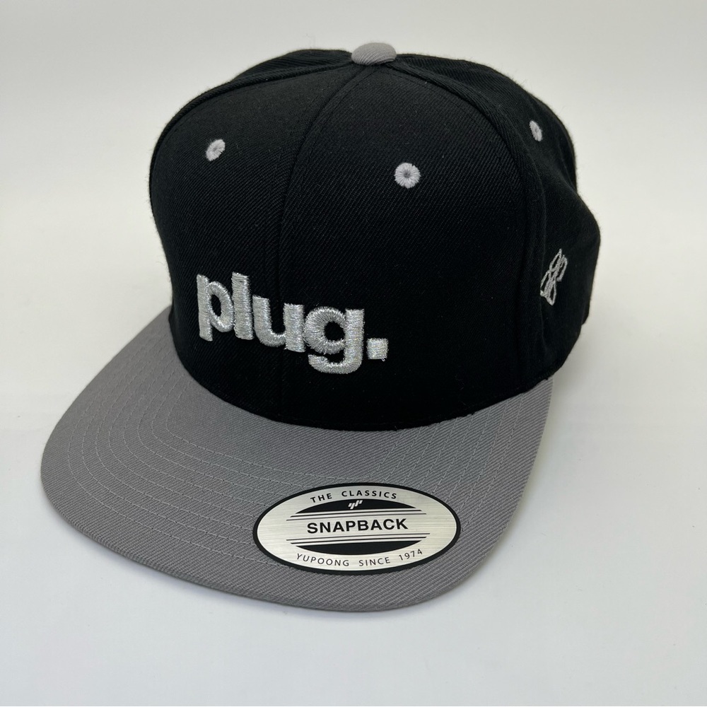 Plug Black with Silver Metallic Lettering SnapBack Yupoong Hat New